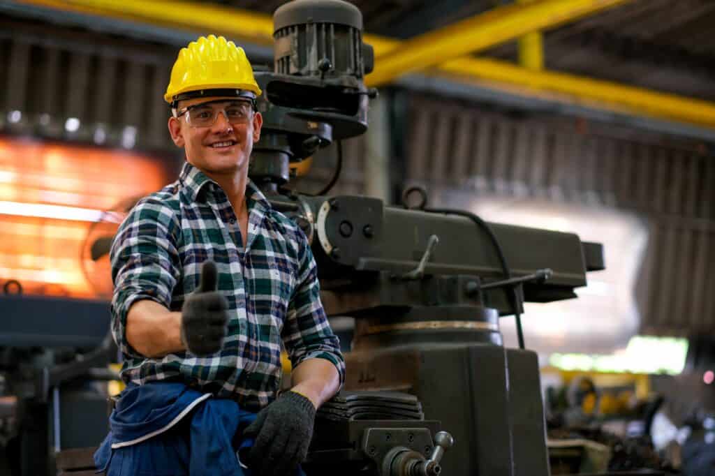 Front view of smart technician or engineer worker with protective helmet stand with confident
